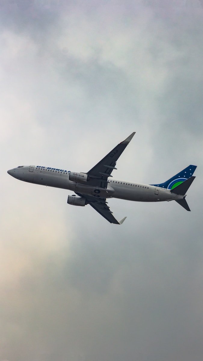 a large passenger jet flying through a cloudy sky